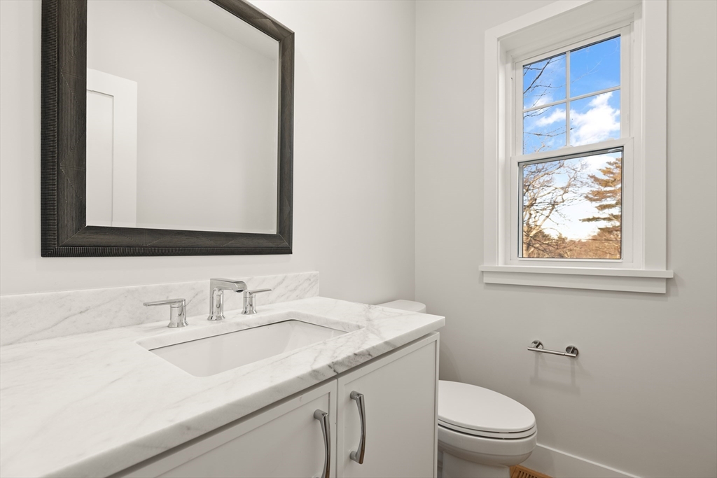 14 Benjamin Road Lexington, MA 02421 - Photo 27 of 35 a bathroom with a granite countertop sink mirror and a toilet