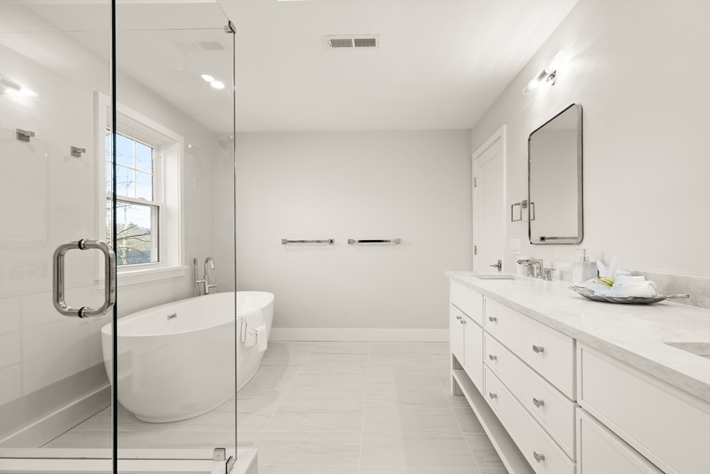 14 Benjamin Road Lexington, MA 02421 - Photo 28 of 35 a en suite bathroom with a granite countertop sink and a mirror