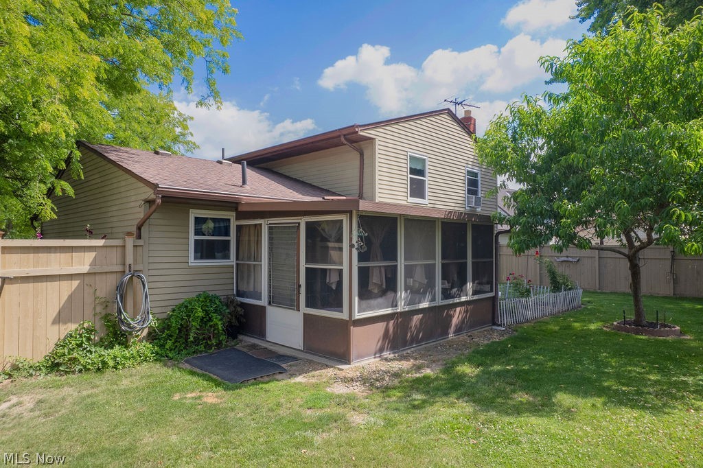 38667 Chestnut Ridge Road Elyria, OH 44035 - Photo 27 of 35 Rear exterior featuring a screened-in porch with a white screen door, light beige siding, and brown trim