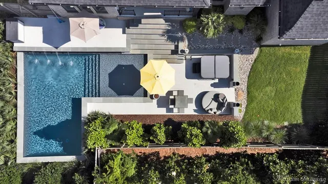 an aerial view of a house with swimming pool garden and patio