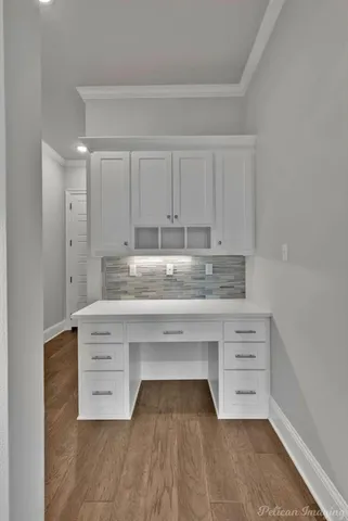 a kitchen with granite countertop white cabinets and sink