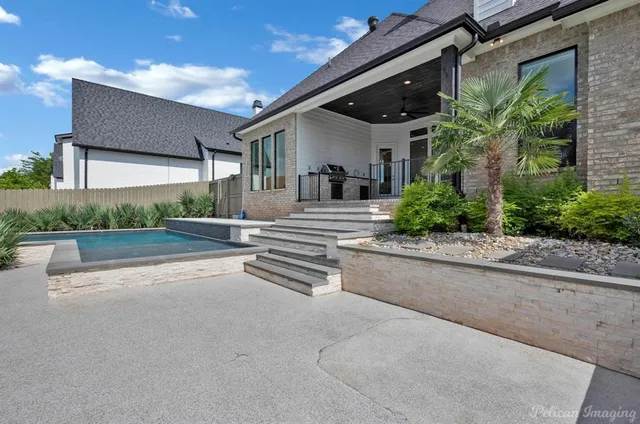 a view of a yard with wooden fence