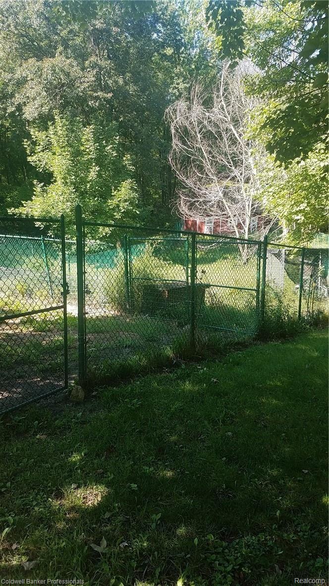 10095 Gibbs Road Clarkston, MI 48348 - Photo 40 of 44 Fenced dog kennel goes all the way down to the barn!