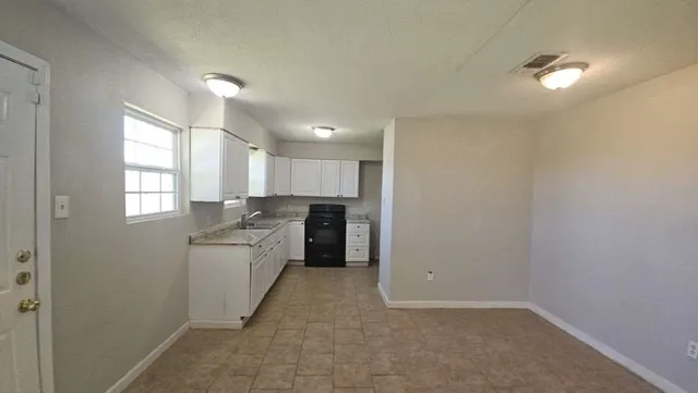 a kitchen with a sink cabinets and window
