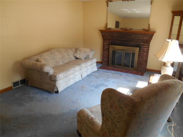 126 Thompson Road Weymouth, MA 02191 - Photo 3 of 10 a living room with furniture and a fireplace
