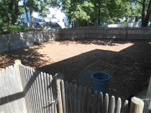 126 Thompson Road Weymouth, MA 02191 - Photo 10 of 10 a view of a yard with wooden fence