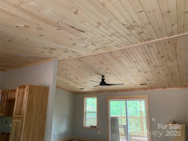 a room with stainless steel appliances wooden floor and window
