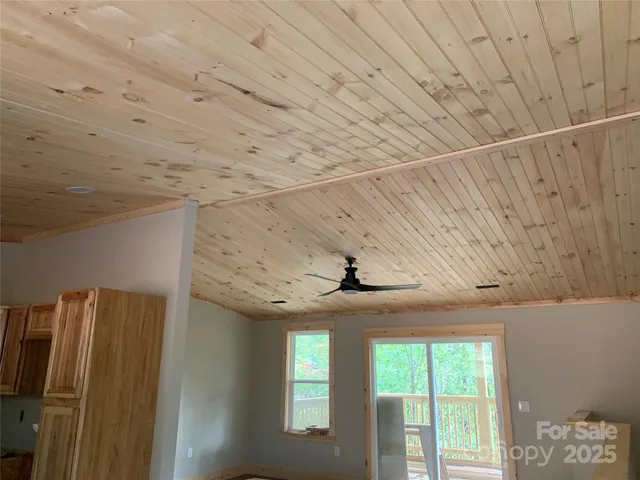 a room with stainless steel appliances wooden floor and window