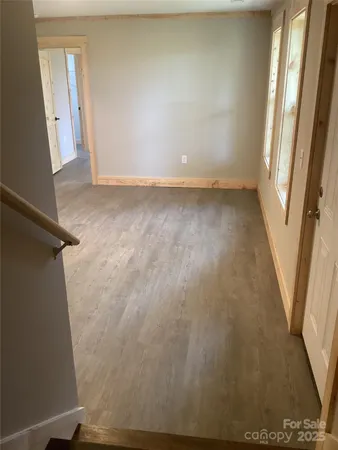 a view of room with window and hardwood floor