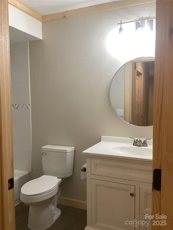 a bathroom with a sink toilet and mirror