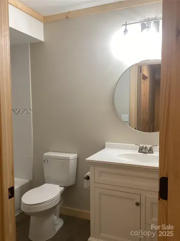 a bathroom with a sink toilet and mirror