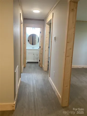 a view of a hallway view with wooden floor and furniture