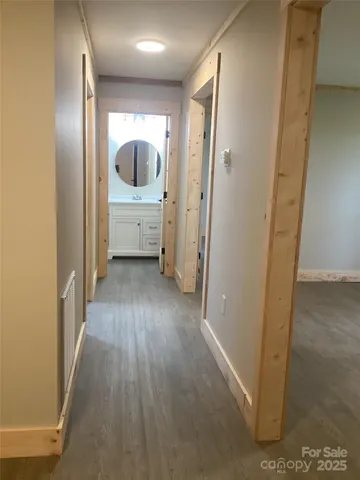 a view of a hallway view with wooden floor and furniture