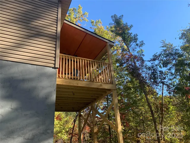 a view of balcony with wooden fence and floor