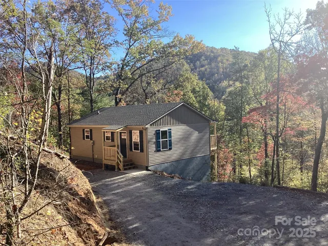 a view of a house with a yard covered in snow