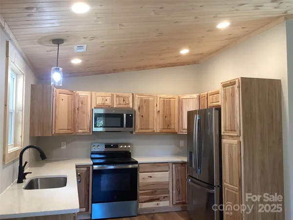 a kitchen with a refrigerator and a sink