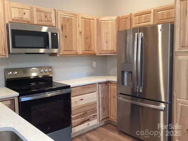 a kitchen with stainless steel appliances a refrigerator stove and microwave