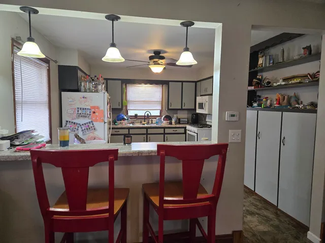 a dining room with wooden floor and window
