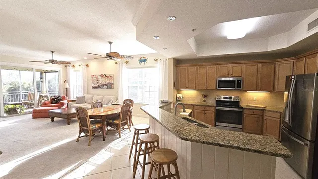 a living room with furniture a flat screen tv and a large window