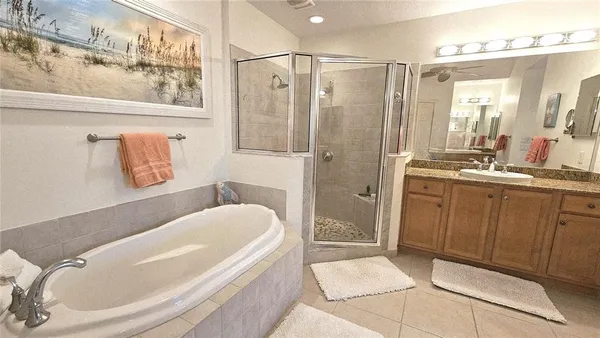 a bedroom with a bed a couch and dresser