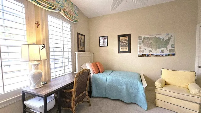 a bedroom with a bed and painting on the wall
