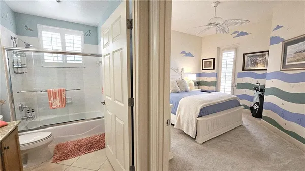 a bedroom with a bed couch and a view of living room