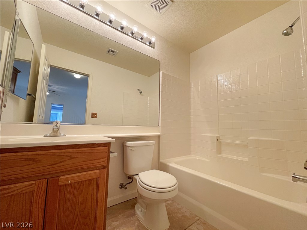 691 Principle Point Avenue Henderson, NV 89012 - Photo 24 of 30 A well-lit primary bathroom features a full bath, large vanity mirror, and ample under-sink storage.