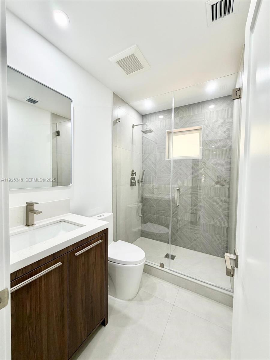 524 Northeast 65th Street, Unit 2 Miami, FL 33138 - Photo 11 of 24 a bathroom with a sink and a mirror