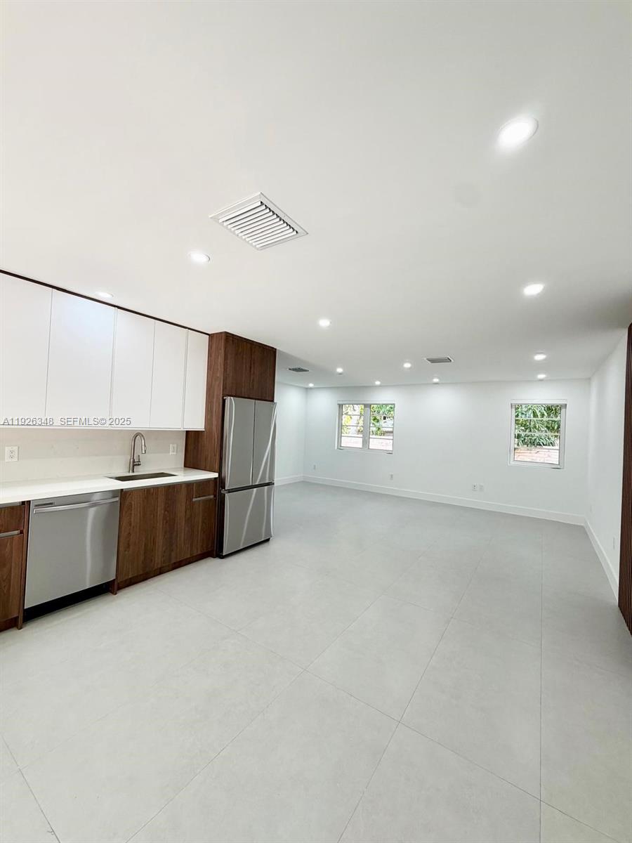 524 Northeast 65th Street, Unit 2 Miami, FL 33138 - Photo 8 of 24 a kitchen with stainless steel appliances a refrigerator and a sink