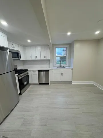 a view of kitchen with microwave and cabinets