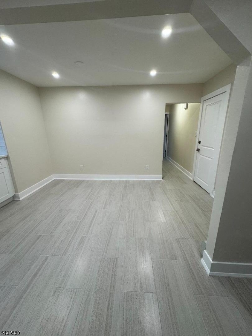 93 Bruen Street Newark, NJ 07105 - Photo 9 of 9 an empty room with wooden floor and windows
