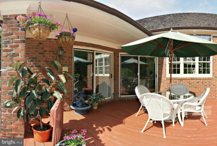 210 South River Landing Road, Unit 210 Edgewater, MD 21037 - Photo 21 of 25 a patio with a table and chairs and potted plants