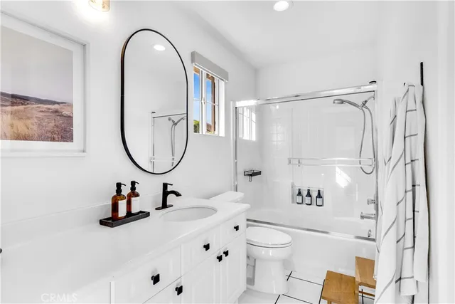 a bathroom with a sink toilet and a mirror