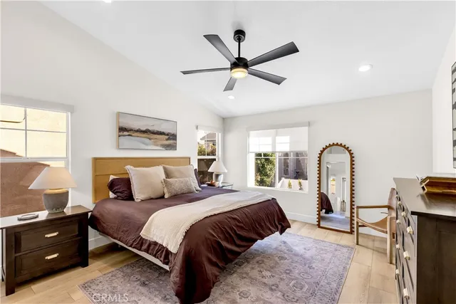 a bedroom with a bed and a dresser next to a window
