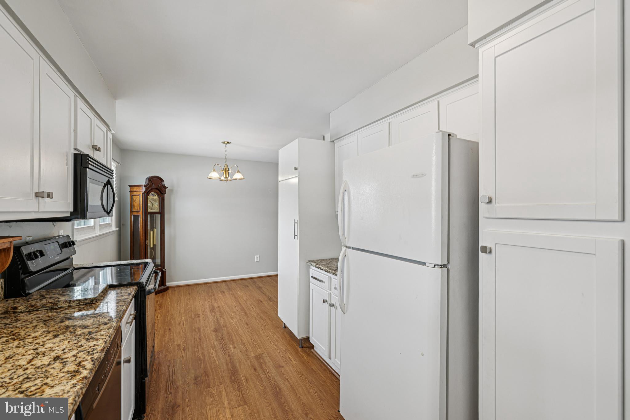 917 Century Street Hampstead, MD 21074 - Photo 14 of 45 a kitchen with stainless steel appliances granite countertop a refrigerator and a stove top oven