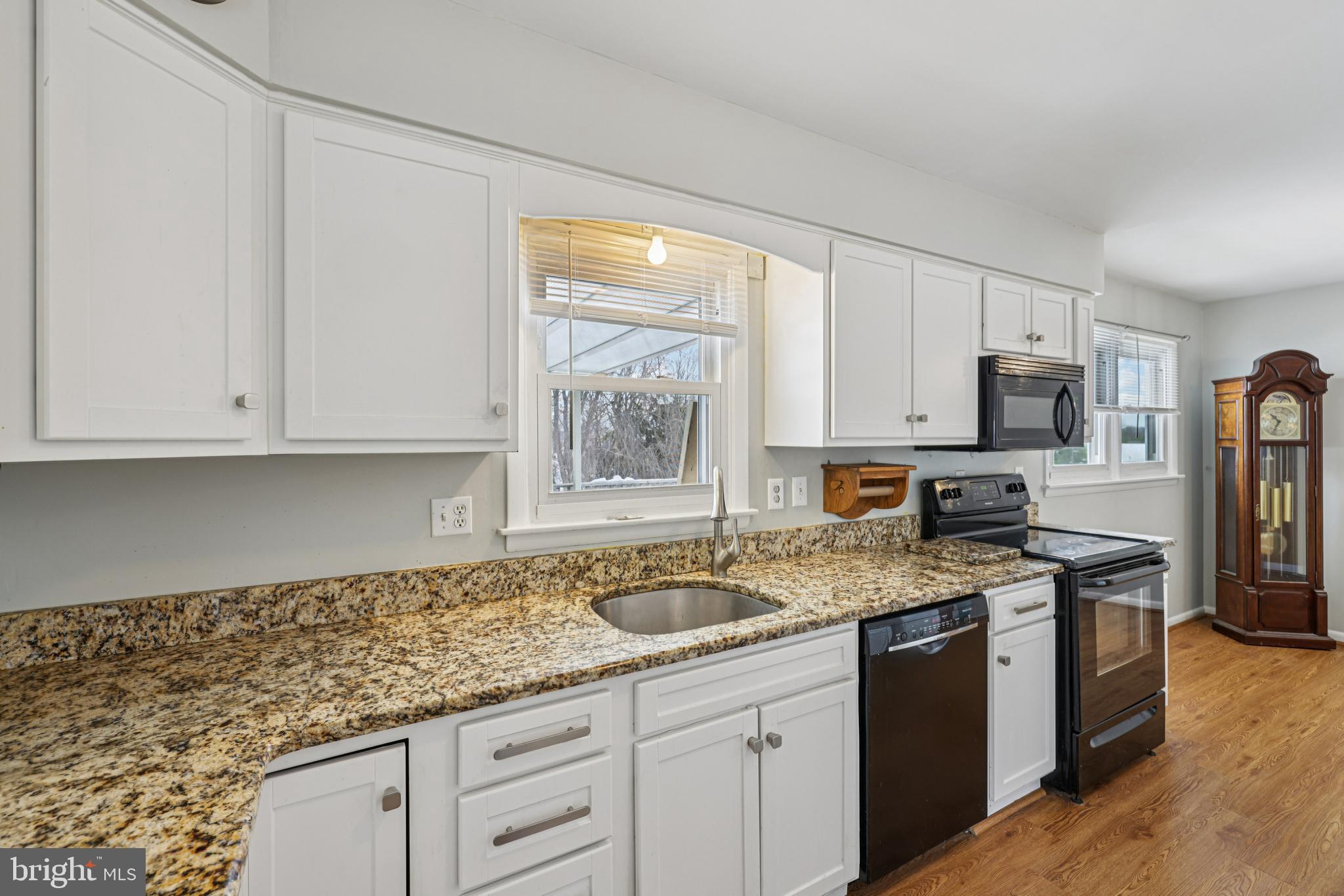 917 Century Street Hampstead, MD 21074 - Photo 15 of 45 a kitchen with granite countertop a sink stainless steel appliances and white cabinets