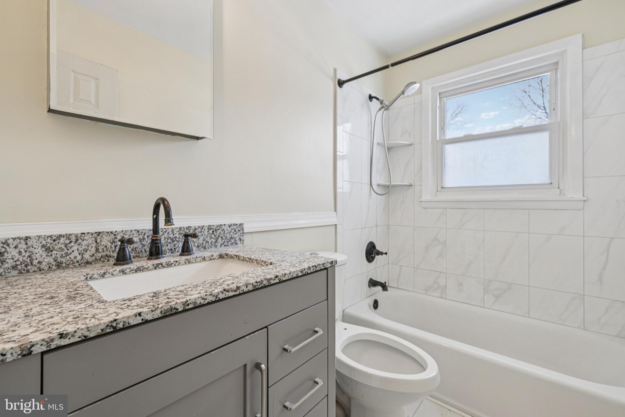 917 Century Street Hampstead, MD 21074 - Photo 22 of 45 a bathroom with a granite countertop sink toilet and shower