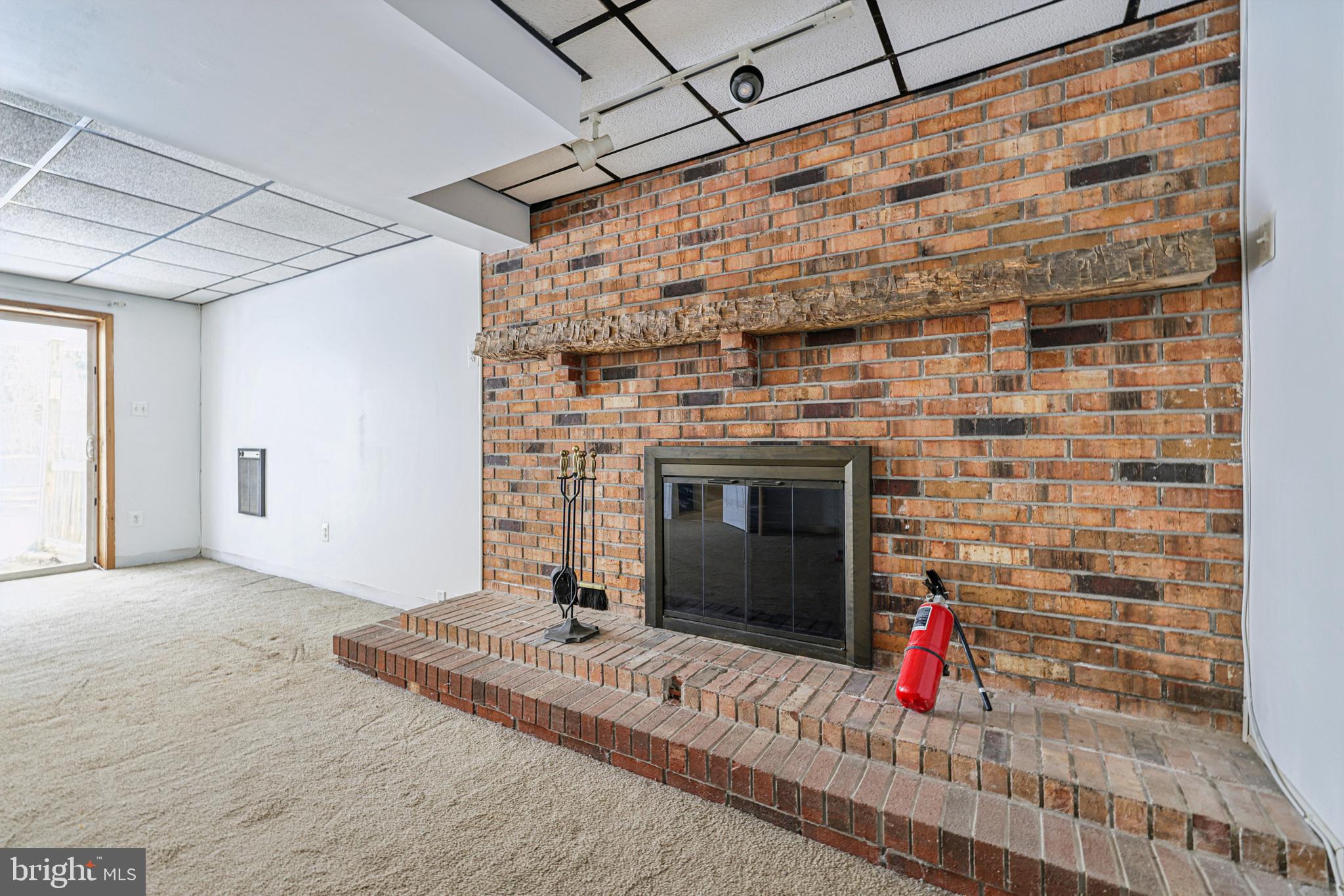 917 Century Street Hampstead, MD 21074 - Photo 32 of 45 a view of empty room with wooden floor and fireplace