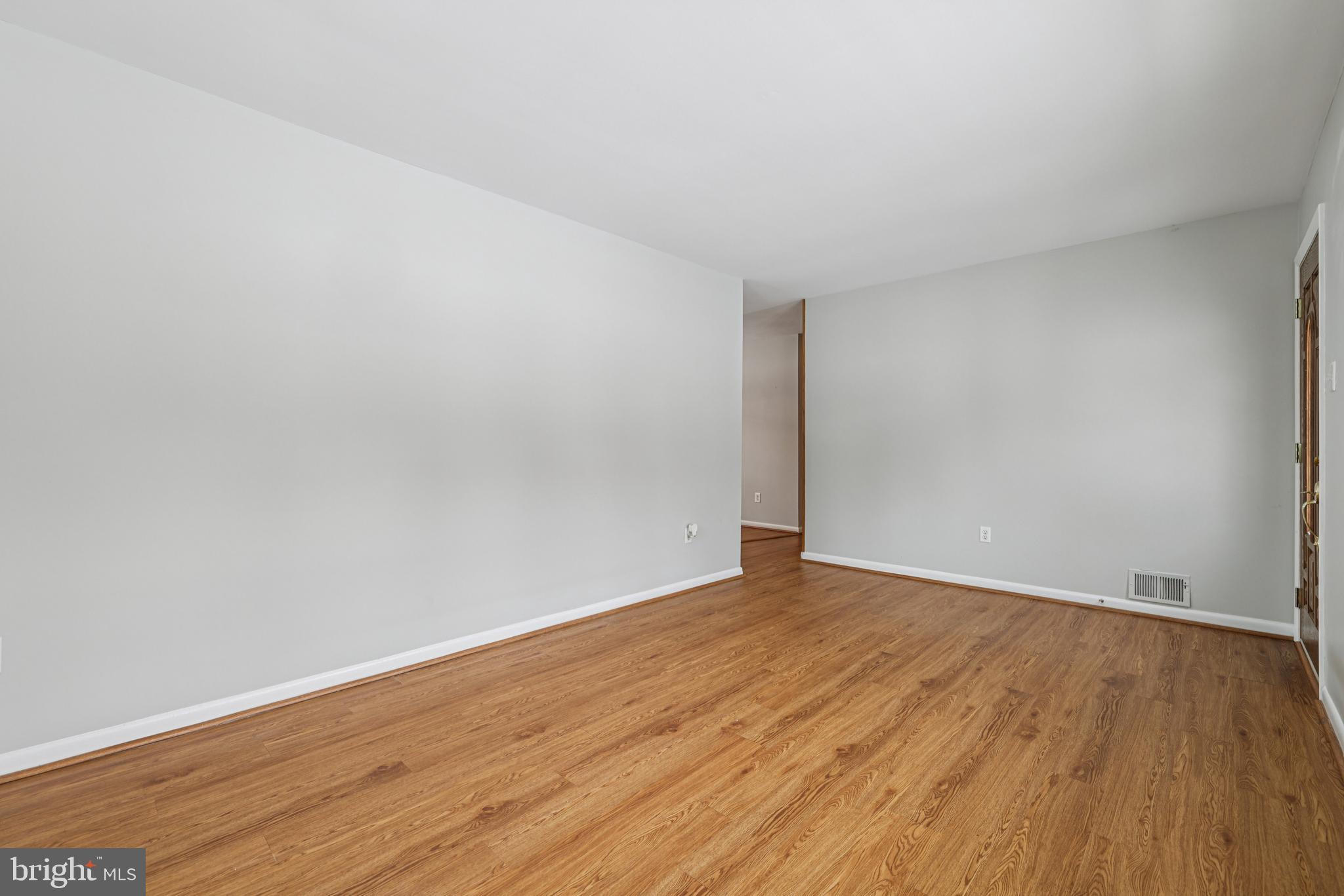 917 Century Street Hampstead, MD 21074 - Photo 7 of 45 a view of an empty room with wooden floor