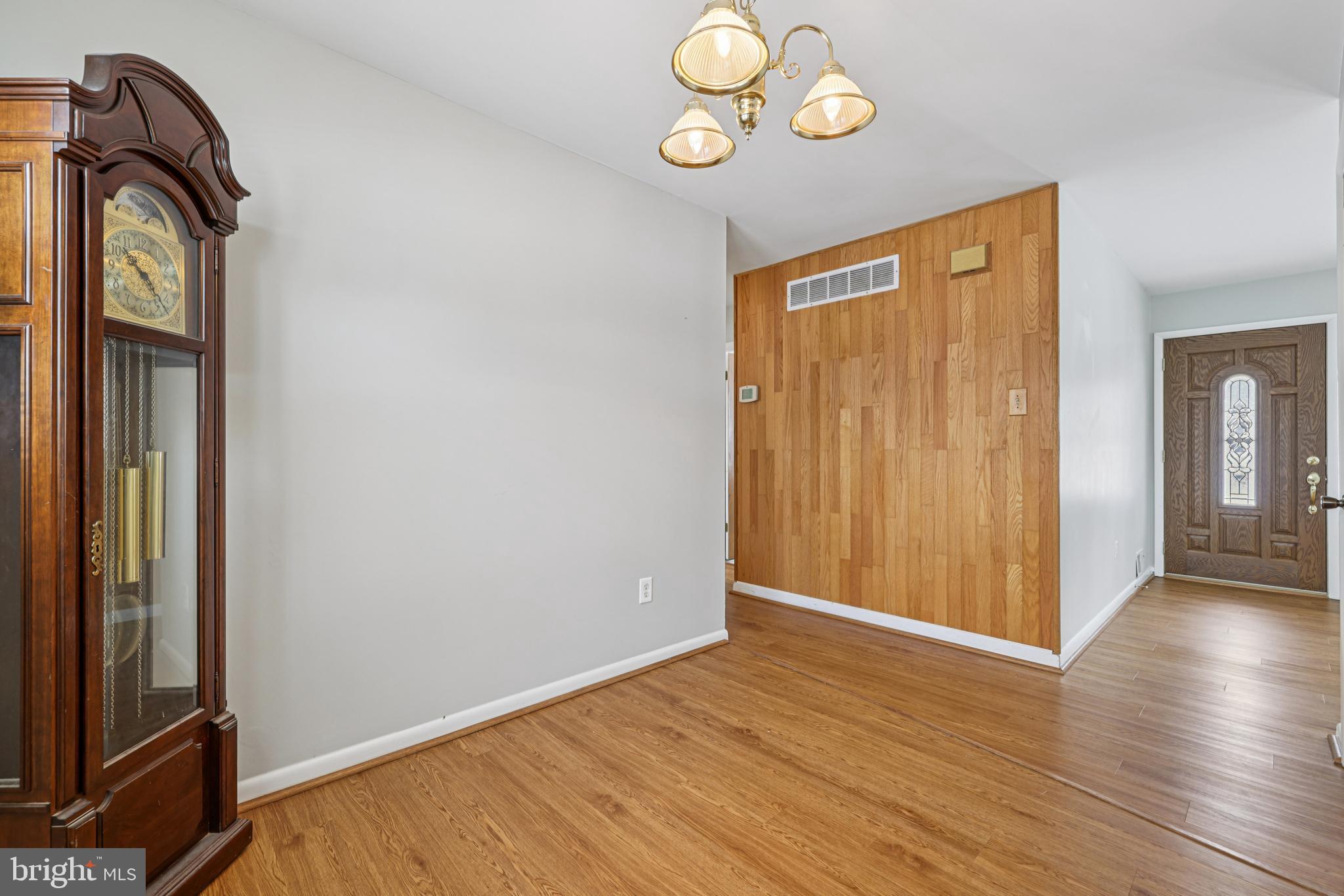 917 Century Street Hampstead, MD 21074 - Photo 8 of 45 an empty room with wooden floor and entrance