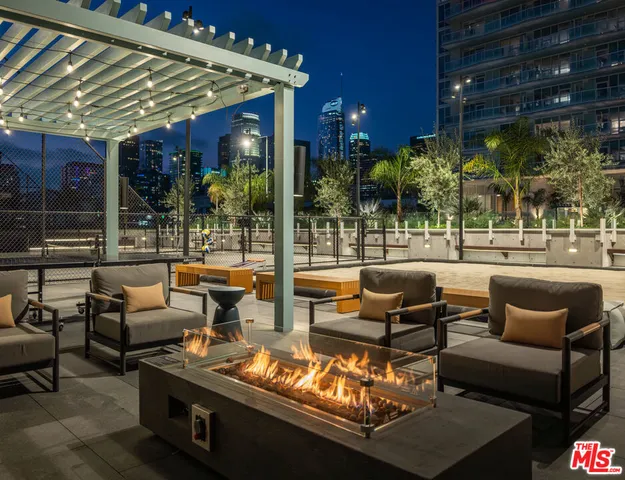 a view of a patio with couches and a table and chairs with wooden floor