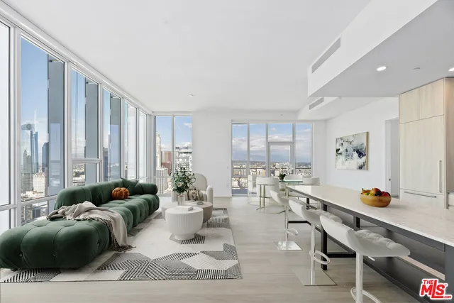 a living room with furniture and large windows