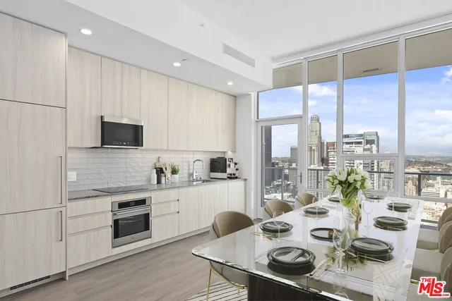 a kitchen with stainless steel appliances granite countertop a sink a stove and a refrigerator