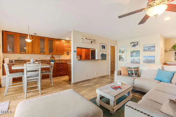 a living room with furniture a flat screen tv and kitchen view