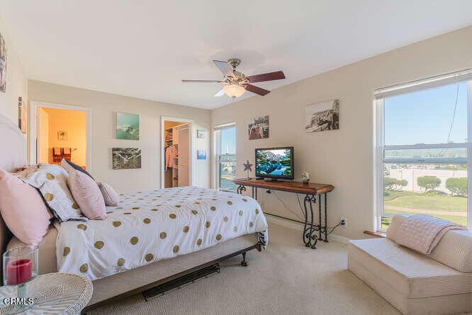 3101 Peninsula Road, Unit 115 Oxnard, CA 93035 - Photo 14 of 36 a bedroom with furniture and a flat screen tv