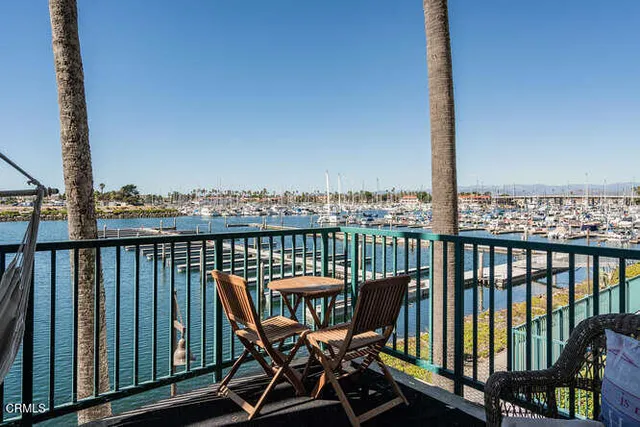 a view of a balcony with wooden chairs