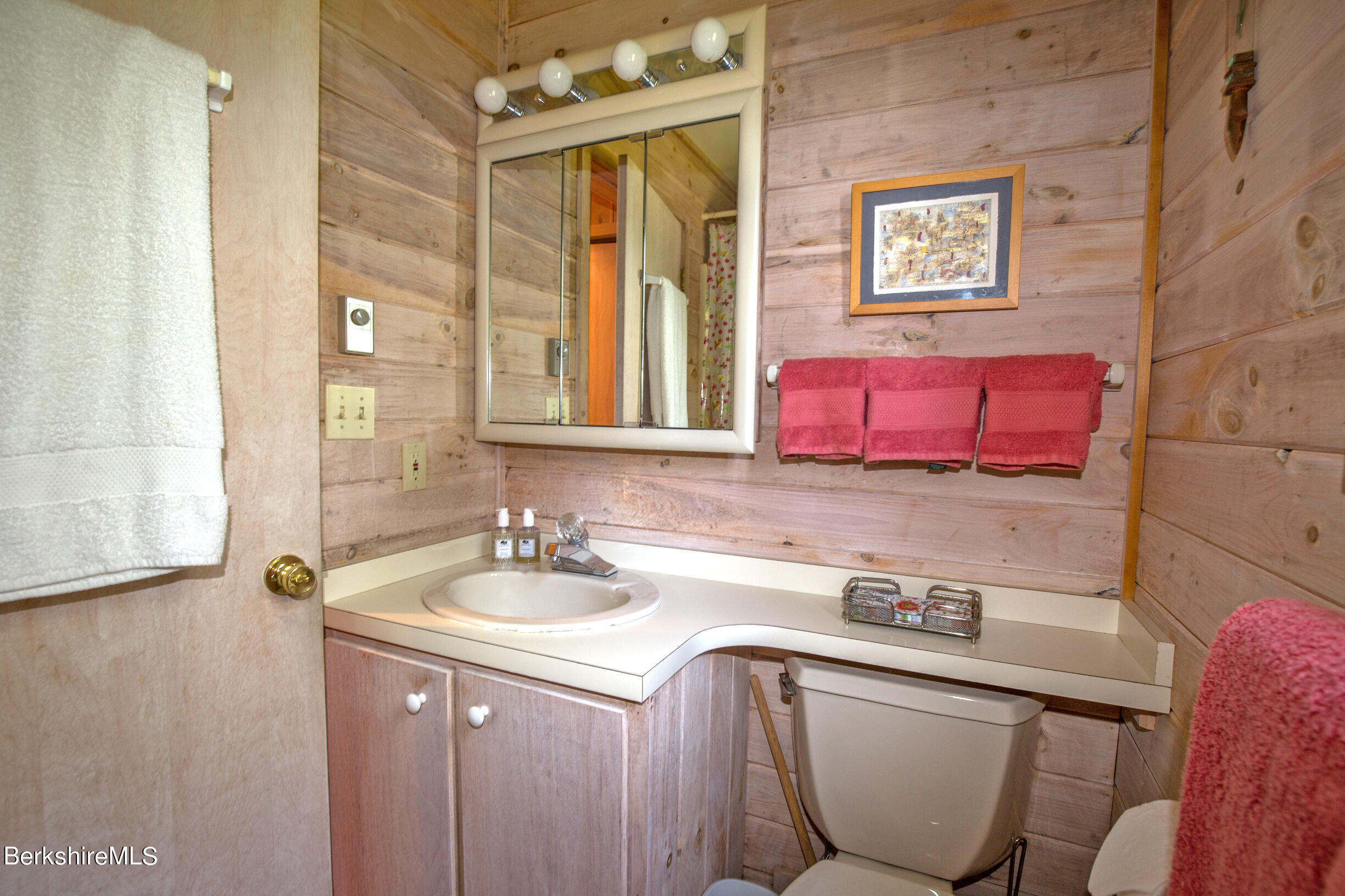 795 Moberg Road Becket, MA 01223 - Photo 20 of 41 a bathroom with a sink and a mirror