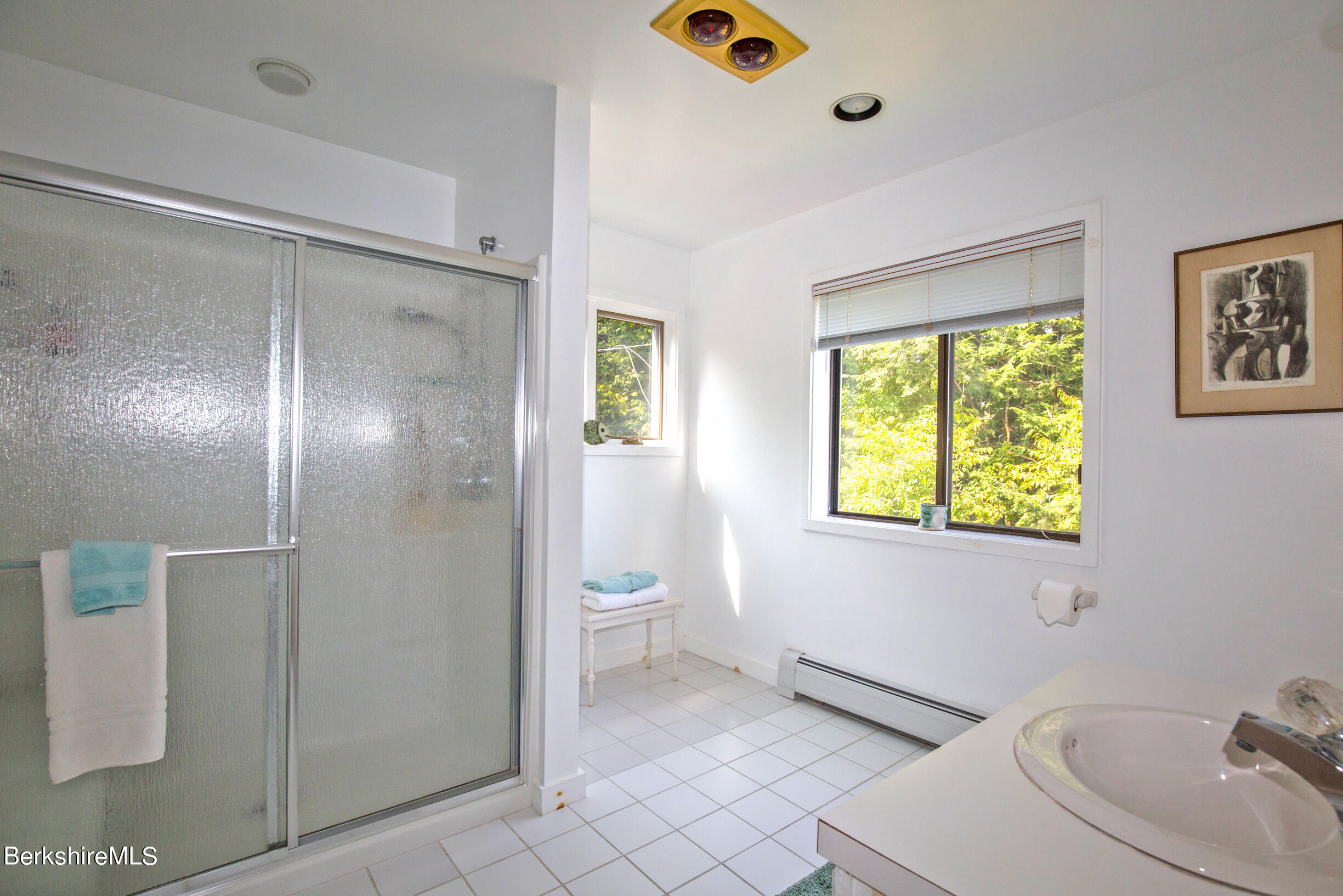 795 Moberg Road Becket, MA 01223 - Photo 26 of 41 a bathroom with a sink mirror vanity and toilet