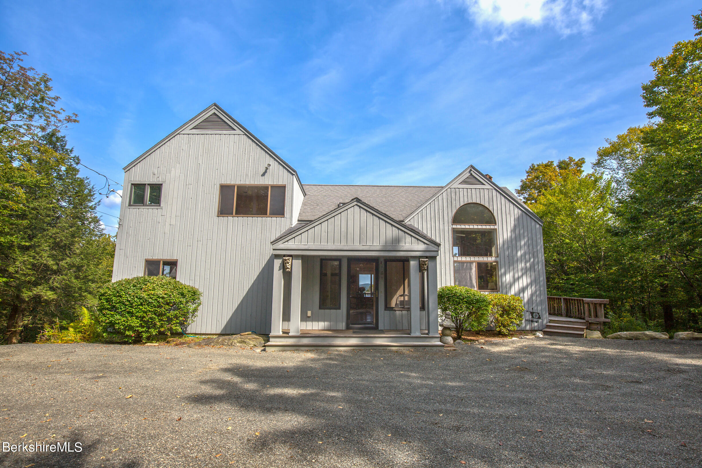 795 Moberg Road Becket, MA 01223 - Photo 3 of 41 a front view of a house with a yard and garage
