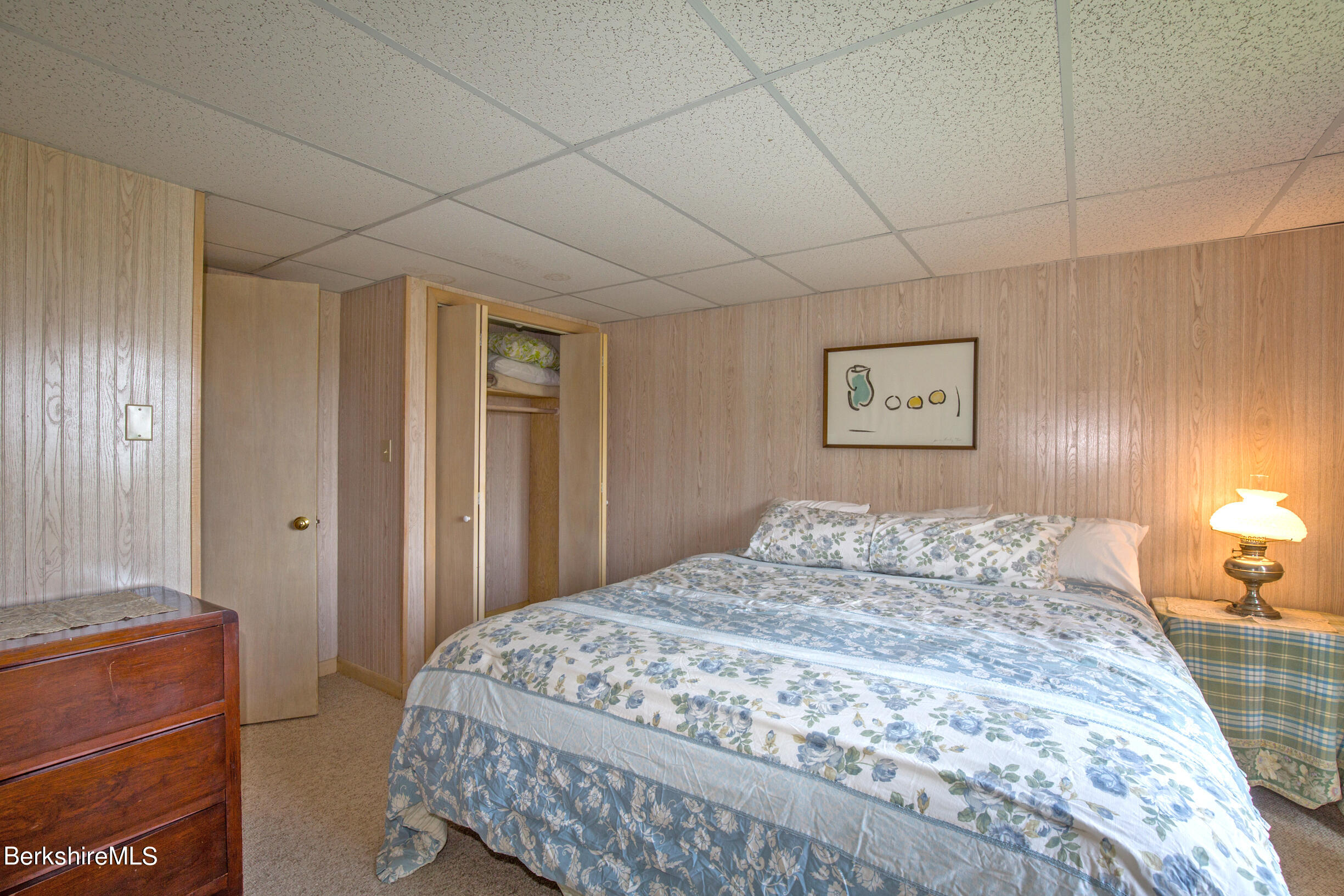 795 Moberg Road Becket, MA 01223 - Photo 34 of 41 a bedroom with a large bed and a chandelier